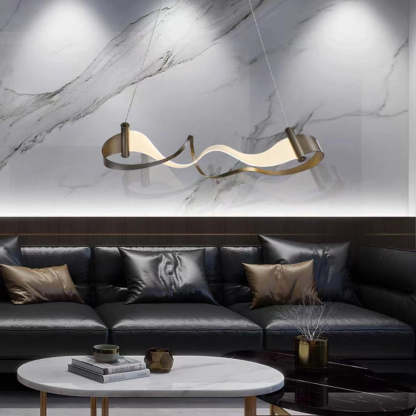 Modern wavy metal pendant light above black leather sofa.