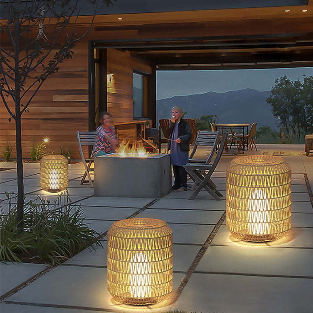 Ritta Rattan Outdoor Floor Lamps illuminating patio with fire pit and children