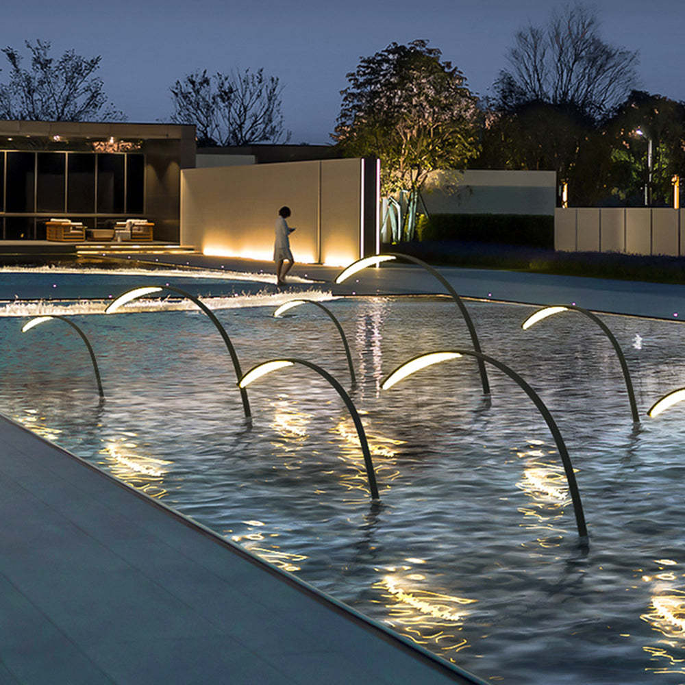 Orr Arc Poolside Lamps illuminate waterscape at night