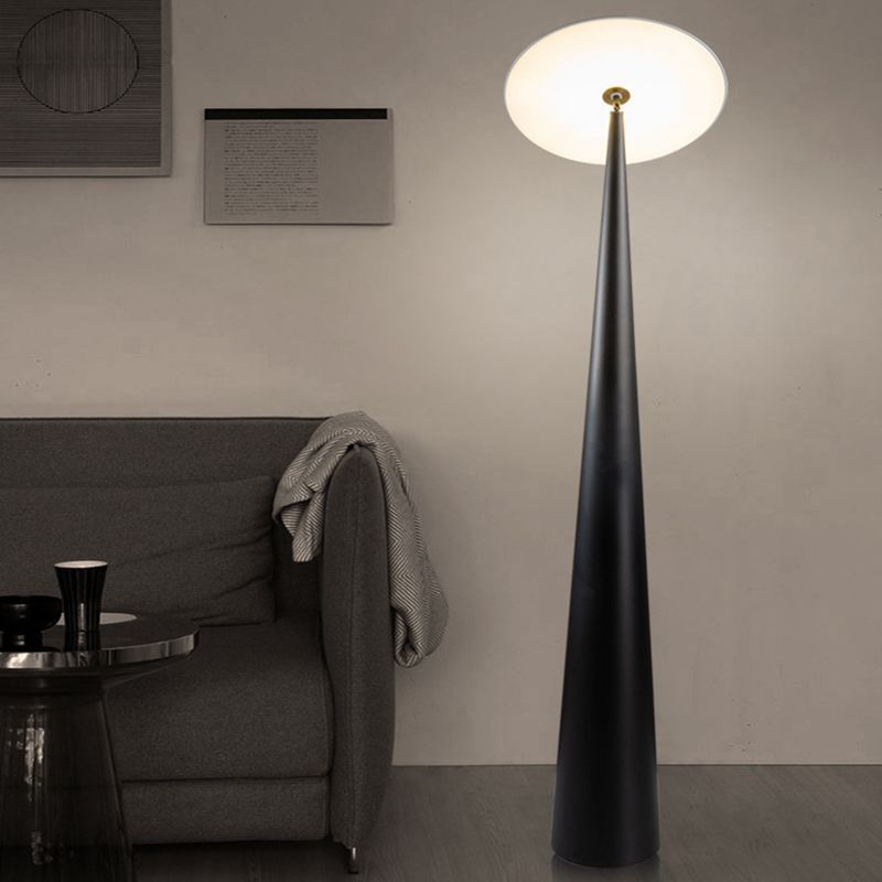 Modern black floor lamp illuminates a living room