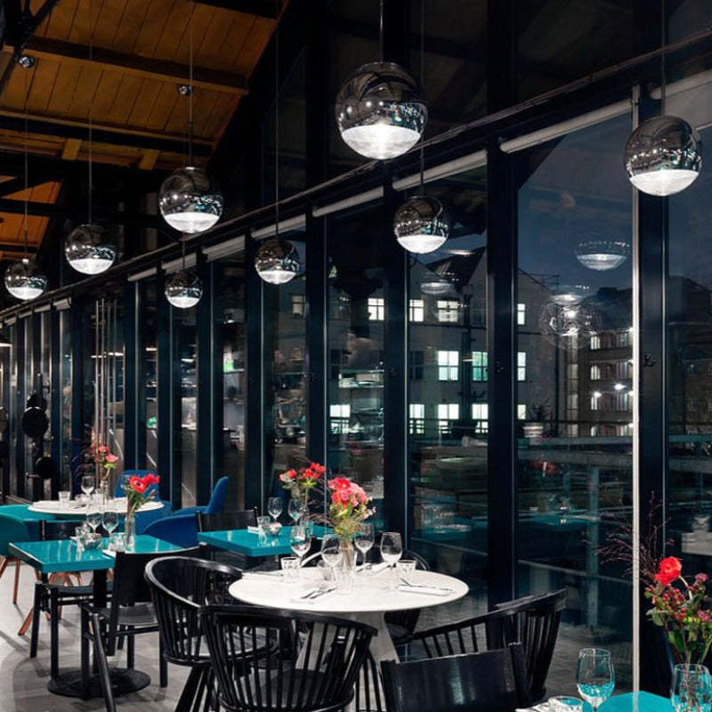 Hailie Industrial Pendant Lights illuminate a restaurant setting