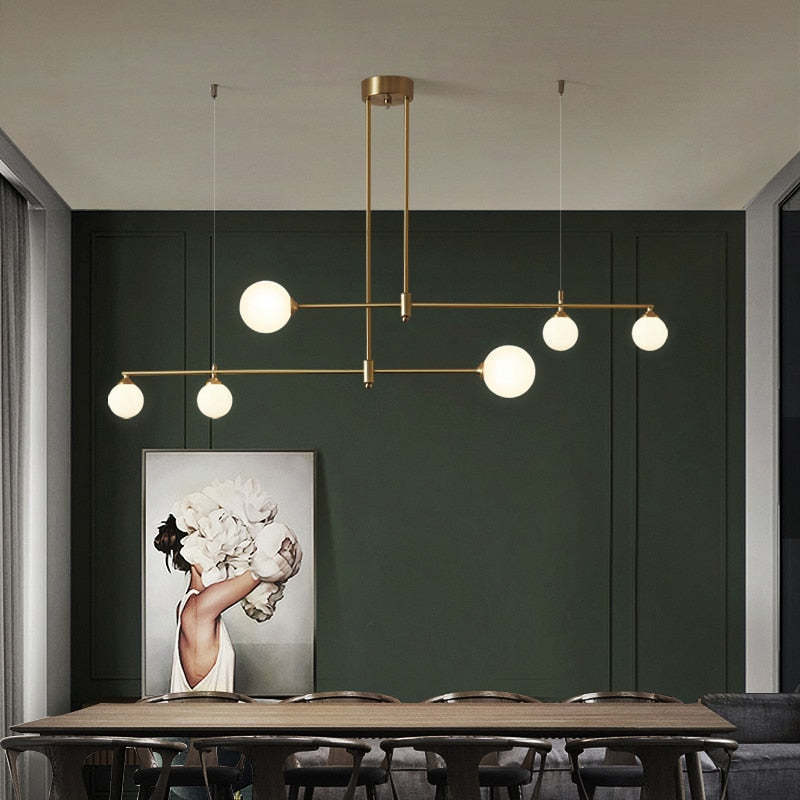 Modern gold pendant light over dining table