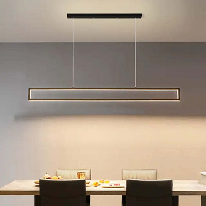 Edge black metal rectangular pendant light over dining table.