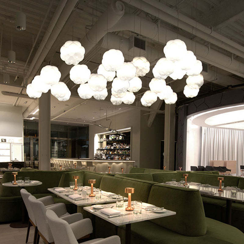Cloud pendant lights illuminating a restaurant dining area
