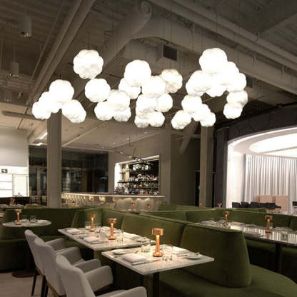 Cloud pendant lights illuminating a restaurant dining area