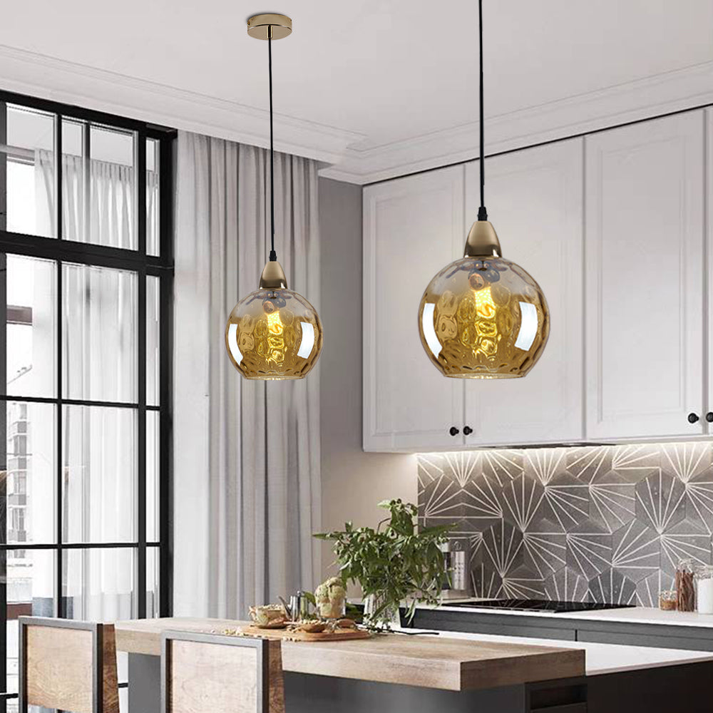 Amber glass pendant lights over kitchen island
