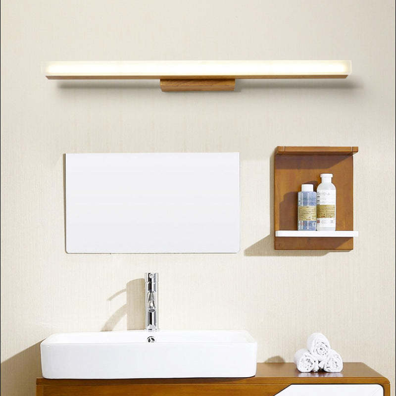 Wooden wall lamp above bathroom sink, minimalist design.