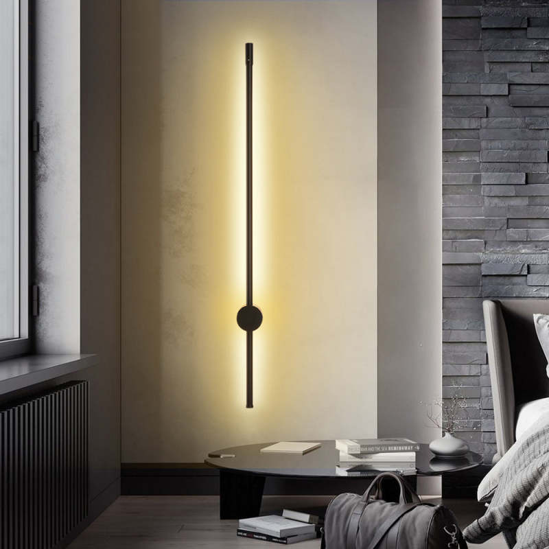 Minimalist black LED wall lamp illuminating a modern interior
