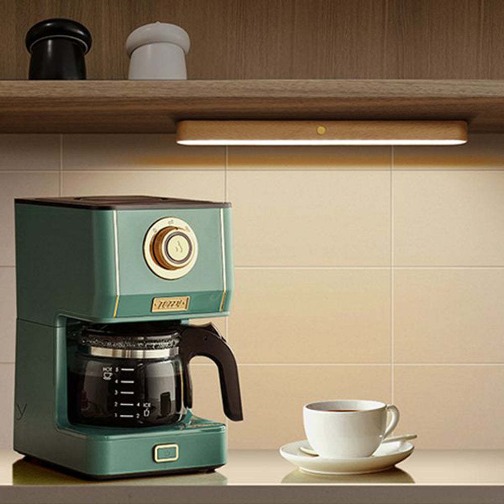 Ozawa wall lamp illuminating coffee maker and cup
