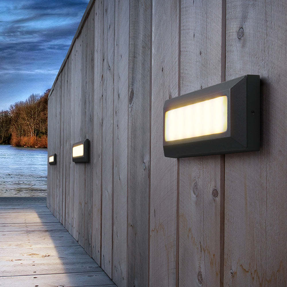 Orr Rectangular Step Lights illuminating a wooden wall, outdoor lighting