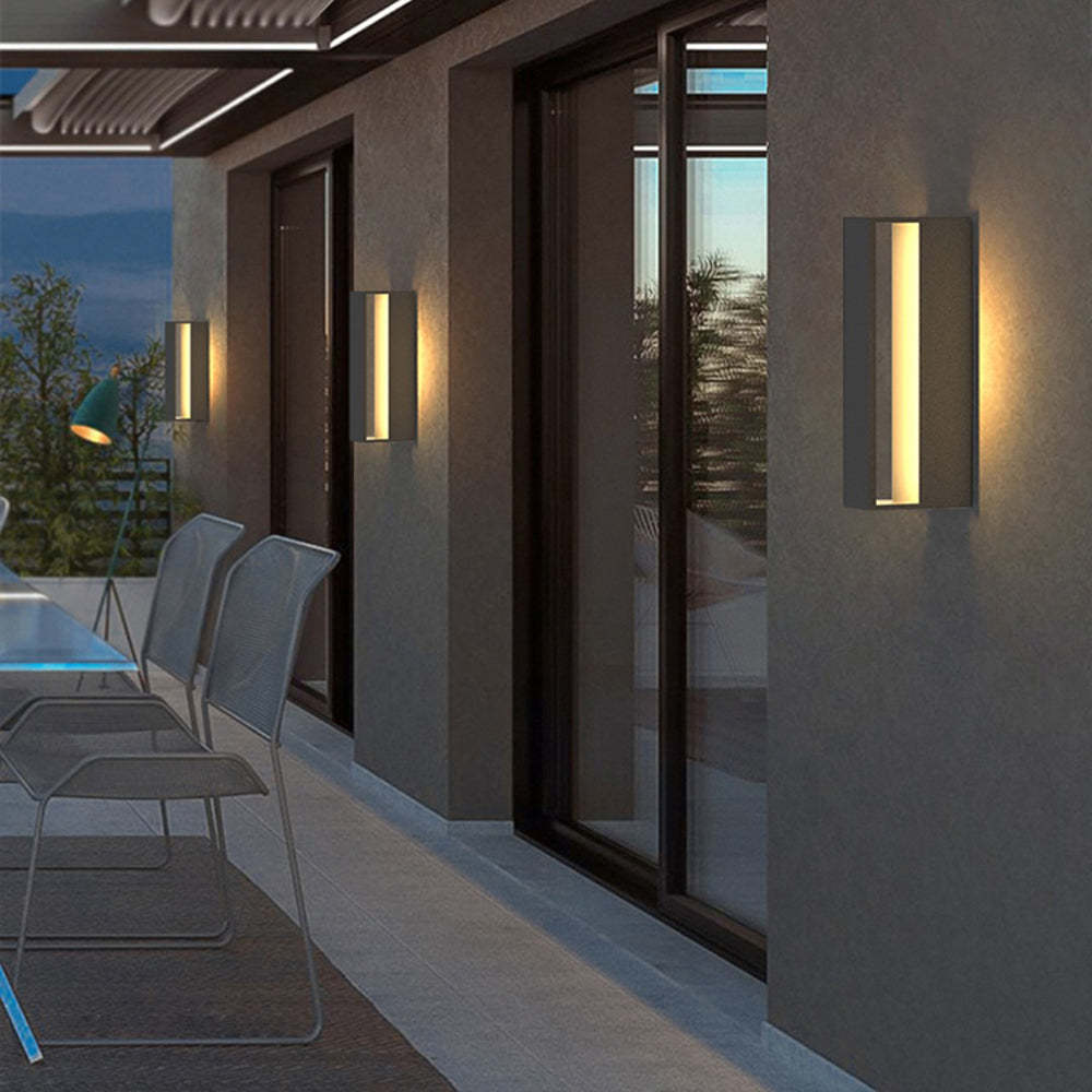 Orr Modern Outdoor Wall Lamps illuminating a patio at dusk
