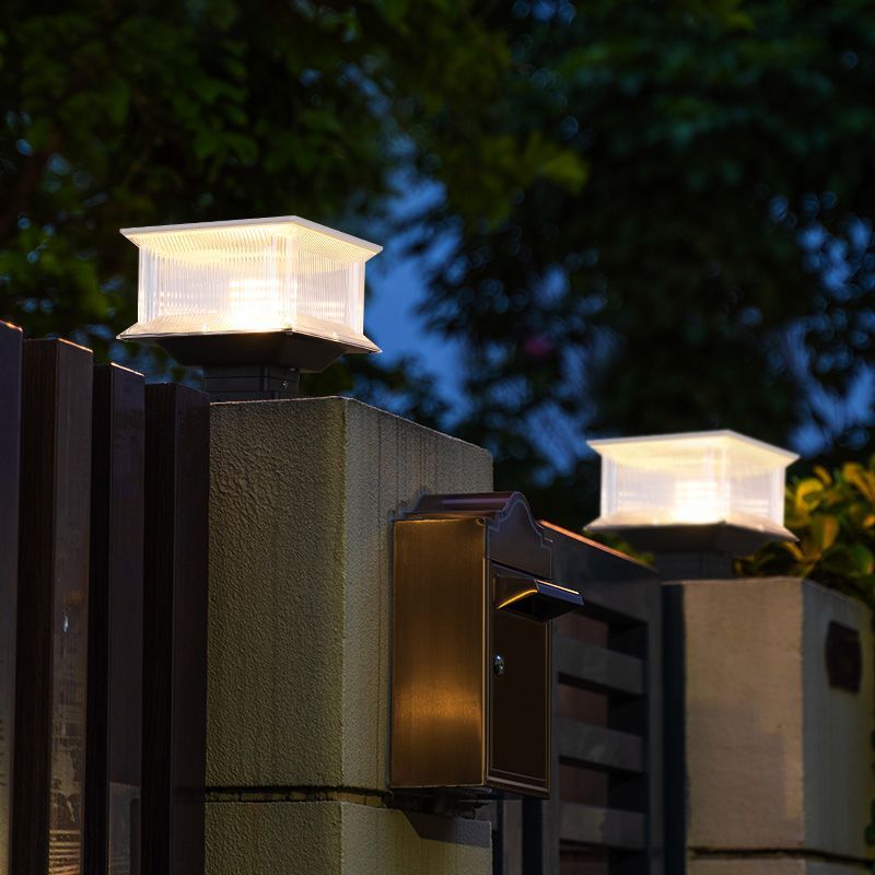 Riley LED solar post light on fence. Modern outdoor lamp.