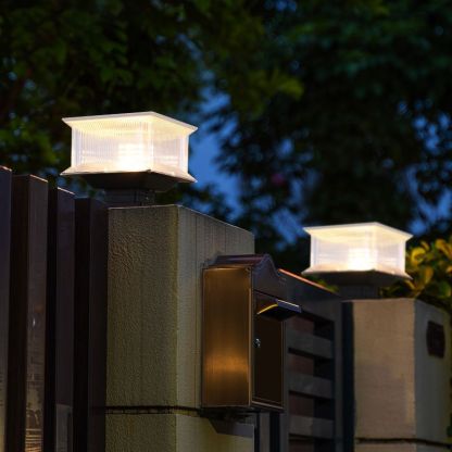 Riley LED solar post light on fence. Modern outdoor lamp.