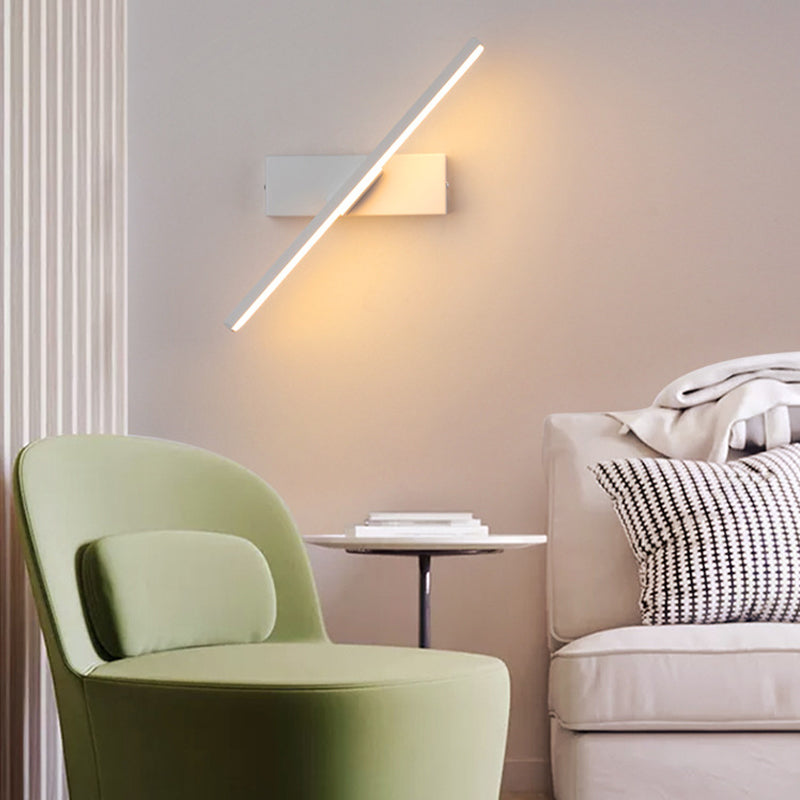 Modern bedroom with rotatable LED wall lamp illuminating the wall