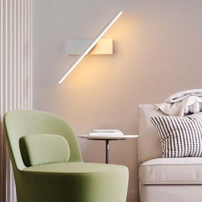 Modern bedroom with rotatable LED wall lamp illuminating the wall