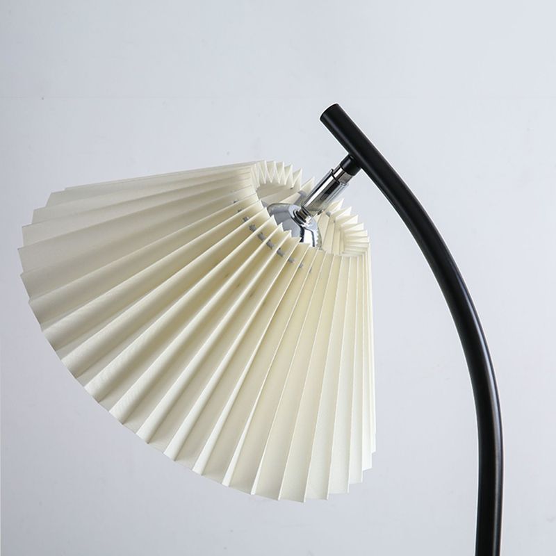 Ozawa floor lamp detail: pleated fabric shade and black arc metal