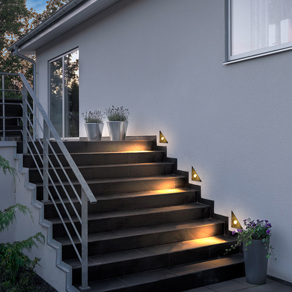 Outdoor staircase with modern triangle step lights, illuminating the steps