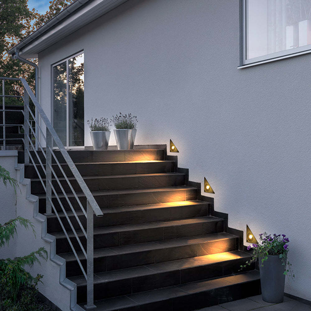 Outdoor staircase with modern triangle step lights, illuminating the steps