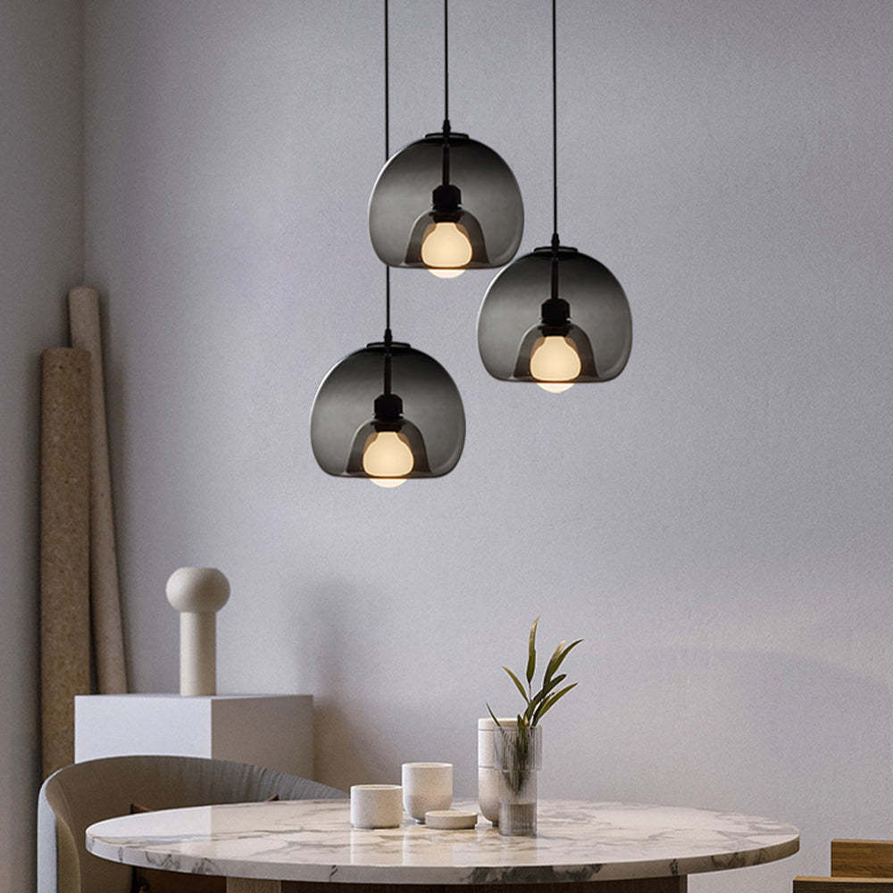 Smoky gray Hailie Globe Pendant Lights above dining table