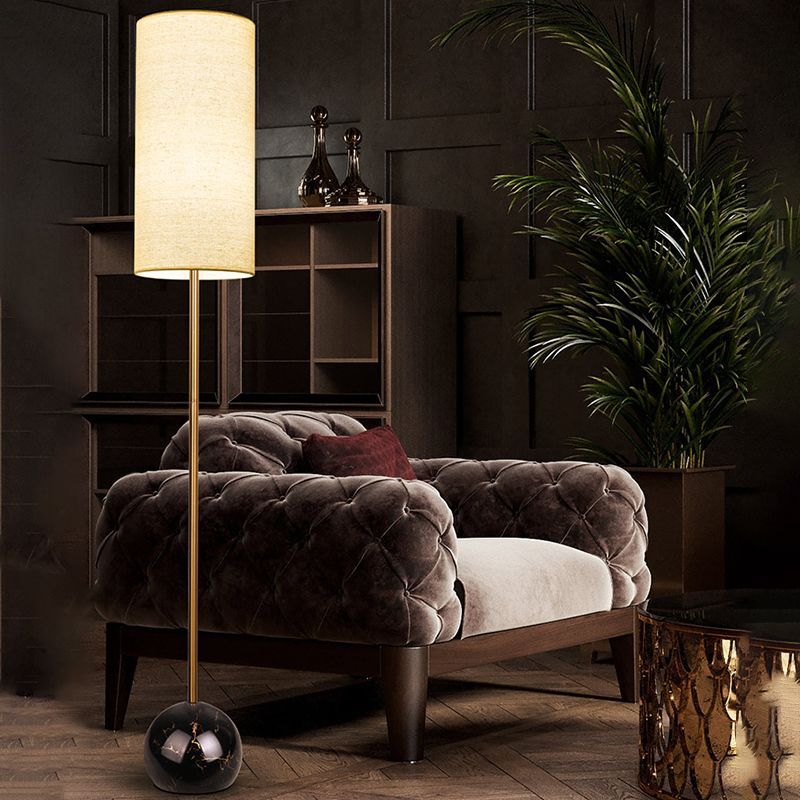 Modern floor lamp illuminating a living room with armchair