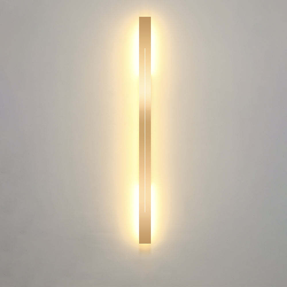 Modern gold LED wall lamp on gray wall, Lassola Edge series