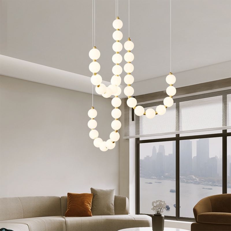 Luxury Valentina chandelier in living room setting, white globe lights