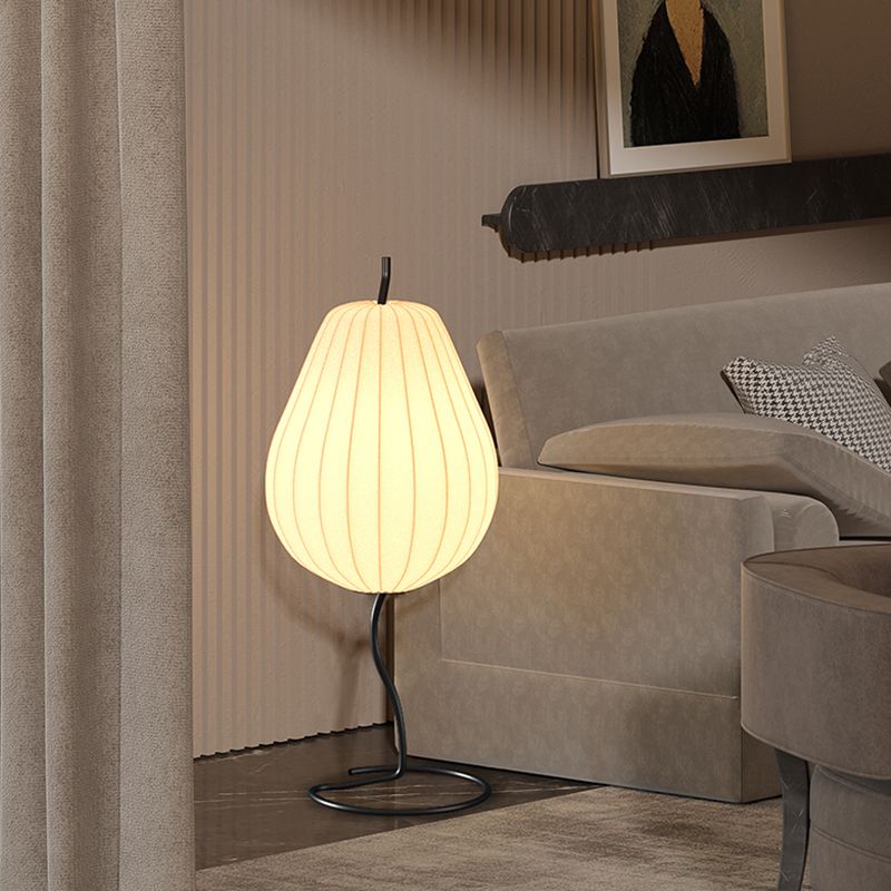 Retro Pear-Shaped Fabric Floor Lamp illuminating a living room setting