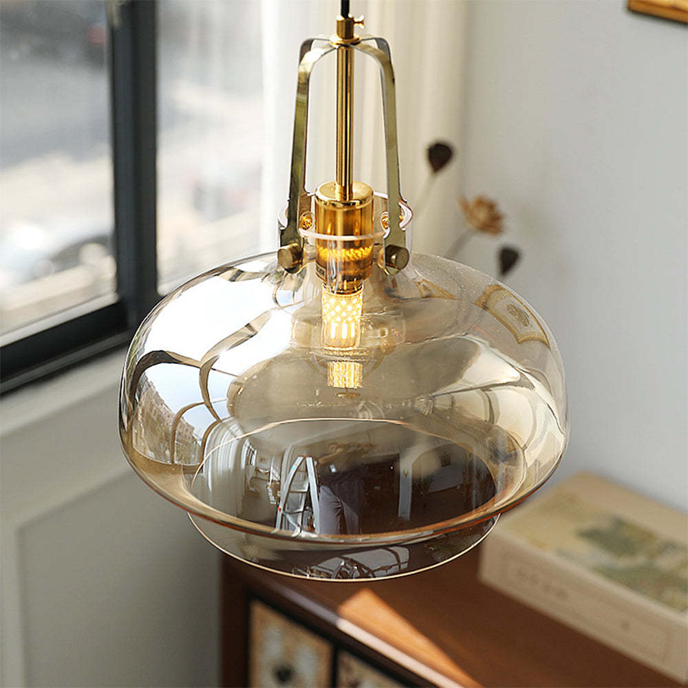 Hailie Pendant Light: Amber glass shade with brass accents, modern design