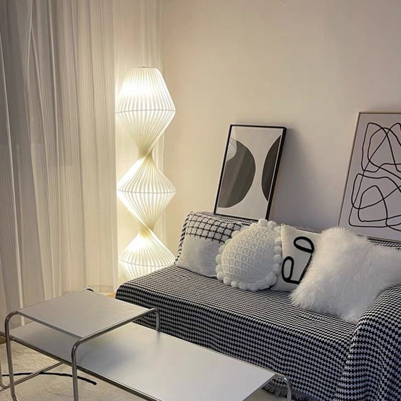 Modern floor lamp in a cozy living room setting.