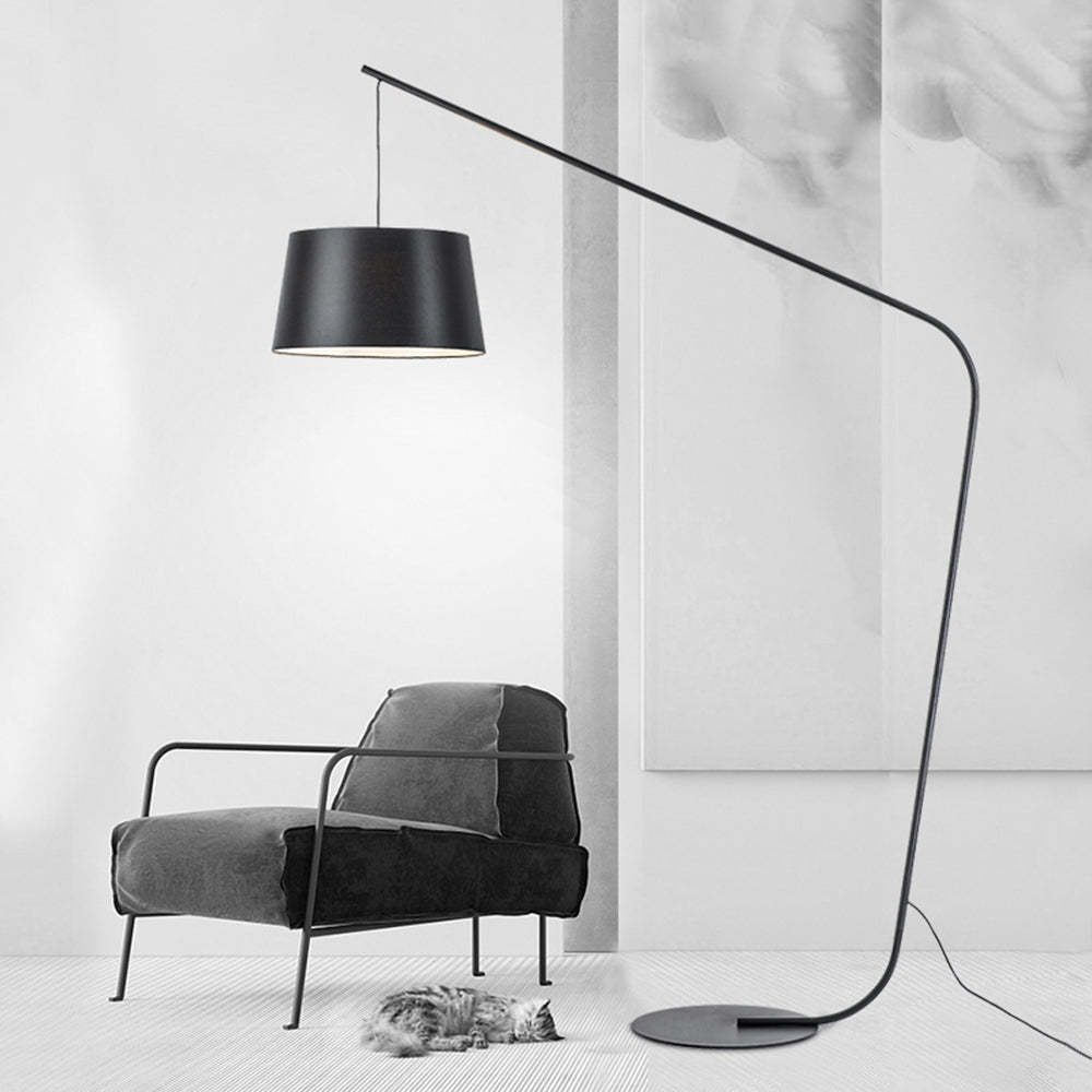 Salgado Floor Lamp beside a modern armchair, with a cat resting