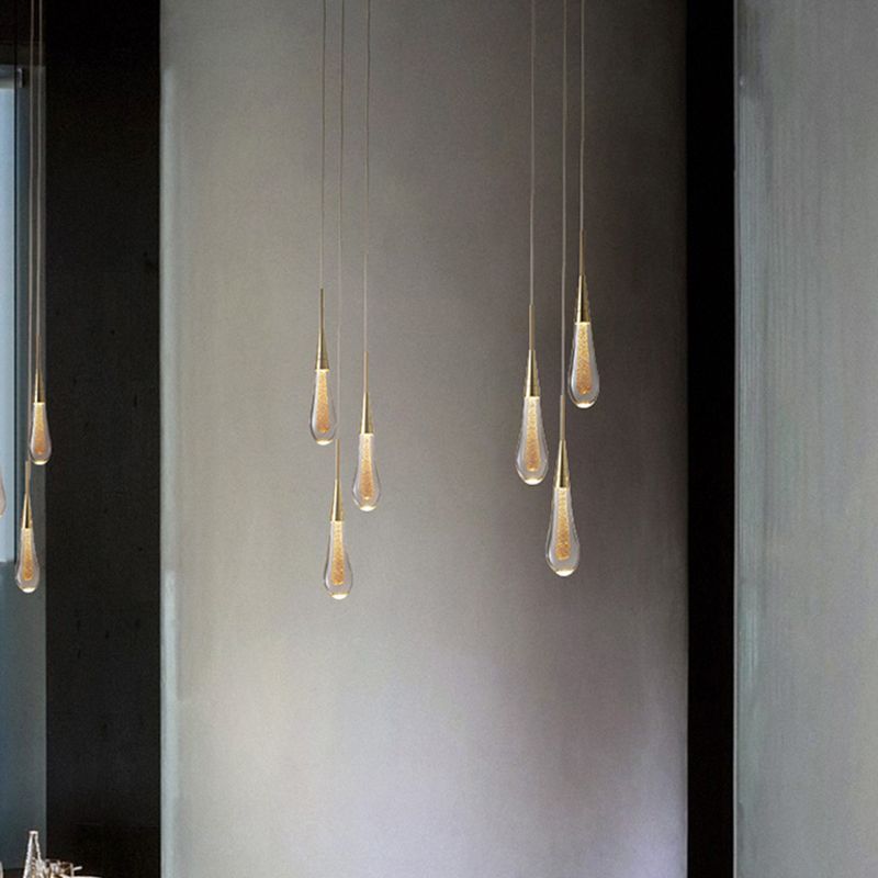 Gold teardrop pendant lights in modern bedroom