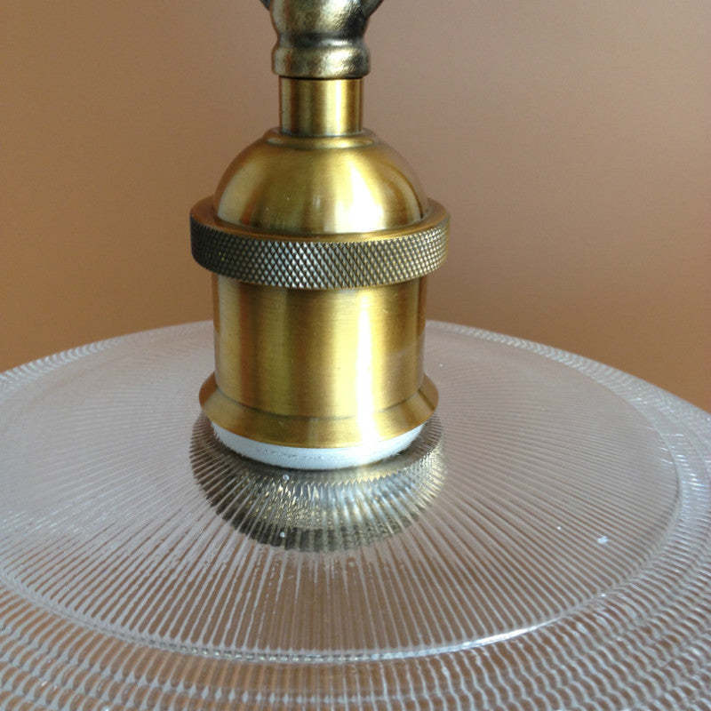 Glass Art Deco pendant light, brass fixture detail.