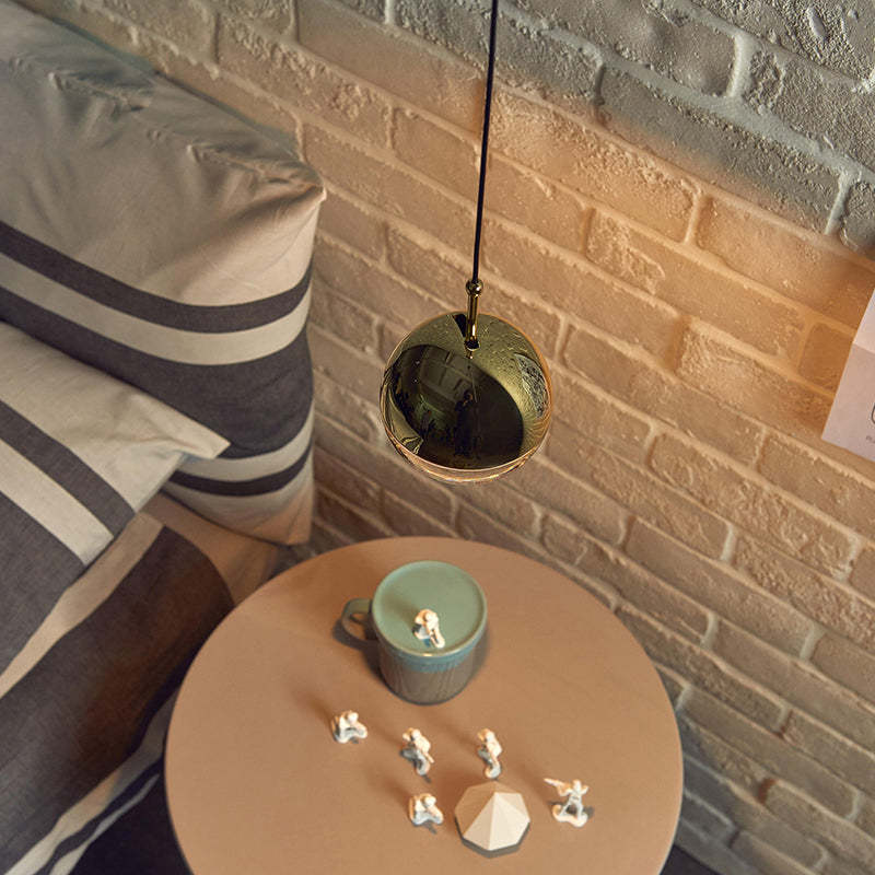 Valentina Ball Pendant Light gold near bedroom setting