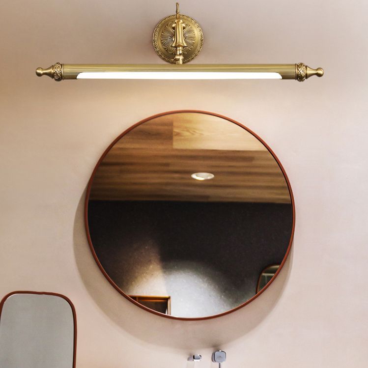 Félicie vintage wall lamp, gold finish, over round mirror.
