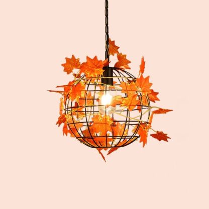 Rustic vine pendant light with orange leaves for dining room lighting.