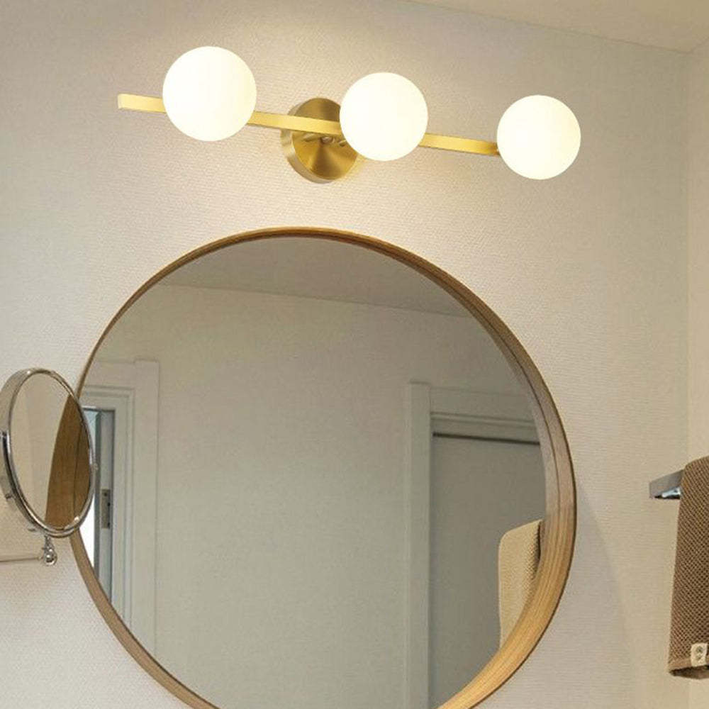 Valentina Globe Wall Lamp above round mirror