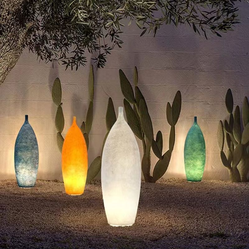 Byers resin bottle floor lamps in garden, Las Sola lighting