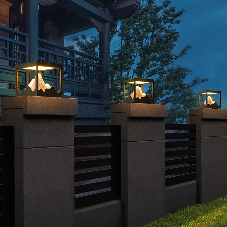 Riley modern mountain LED outdoor lamp on fence posts.