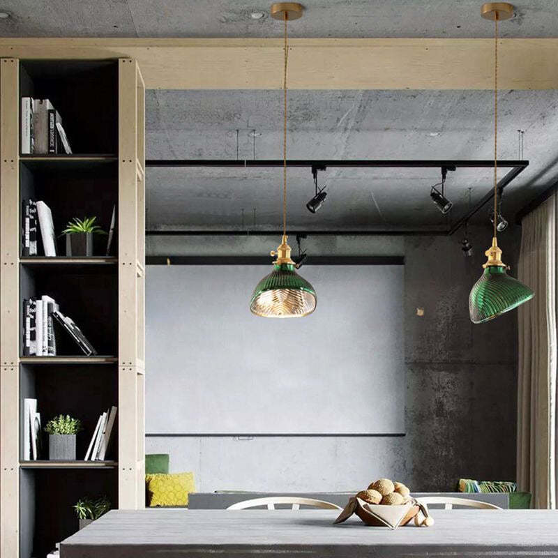 Green glass pendant lights over dining table, Lassola lighting
