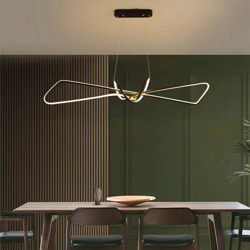 Geometric metal pendant light over dining table. Modern lighting.