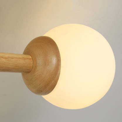Ozawa dimmable ceiling light with wooden arm and glass globe.