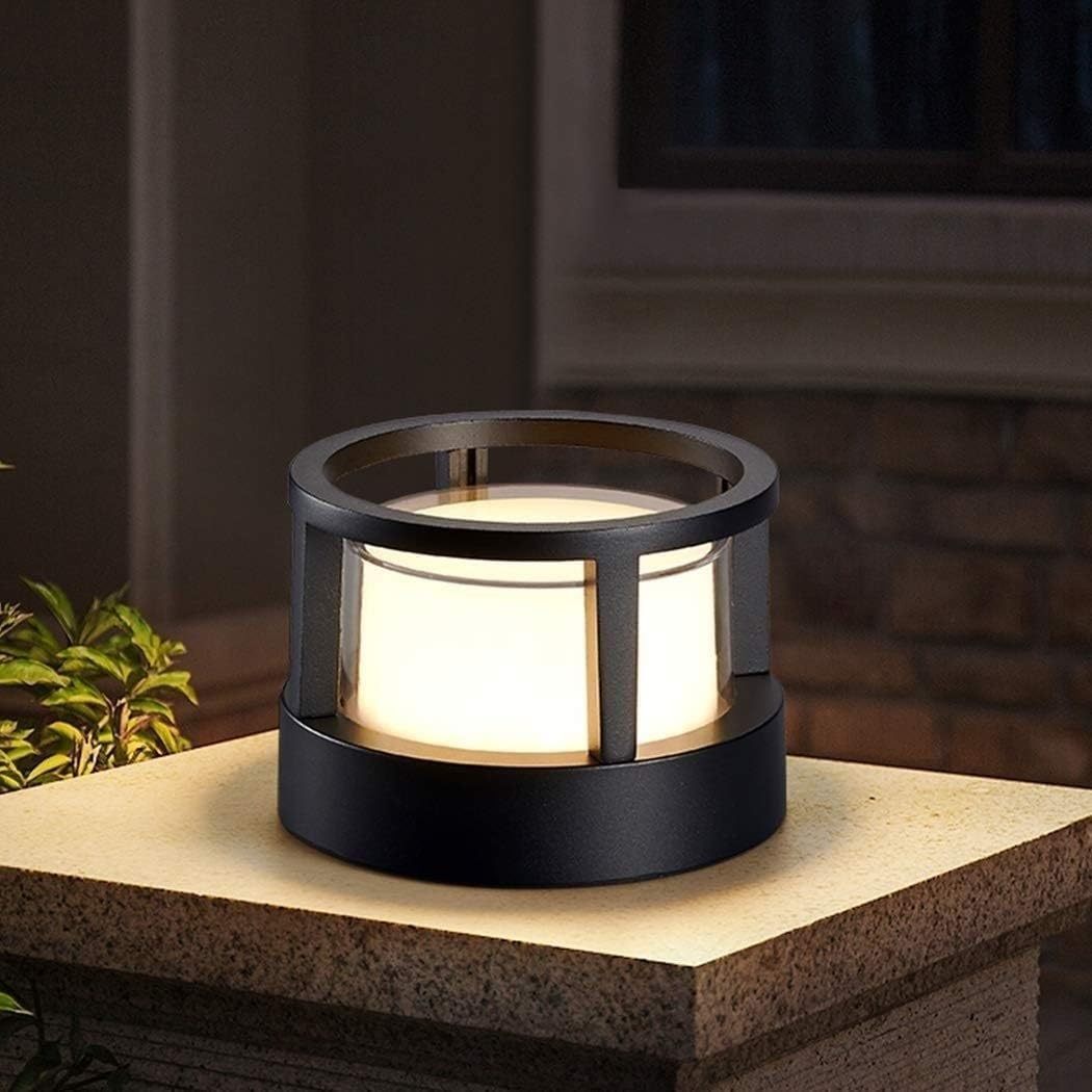 Pena Cylindrical Bollard Light glowing softly outdoors