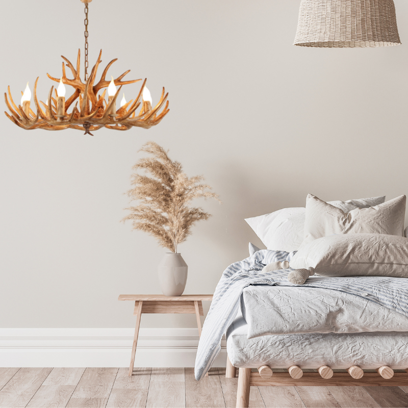 Resin deer antler chandelier lighting above bed.