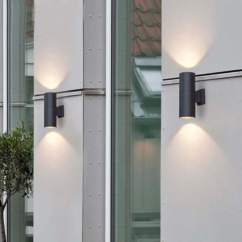 Black Orr outdoor wall lamp illuminating a wall