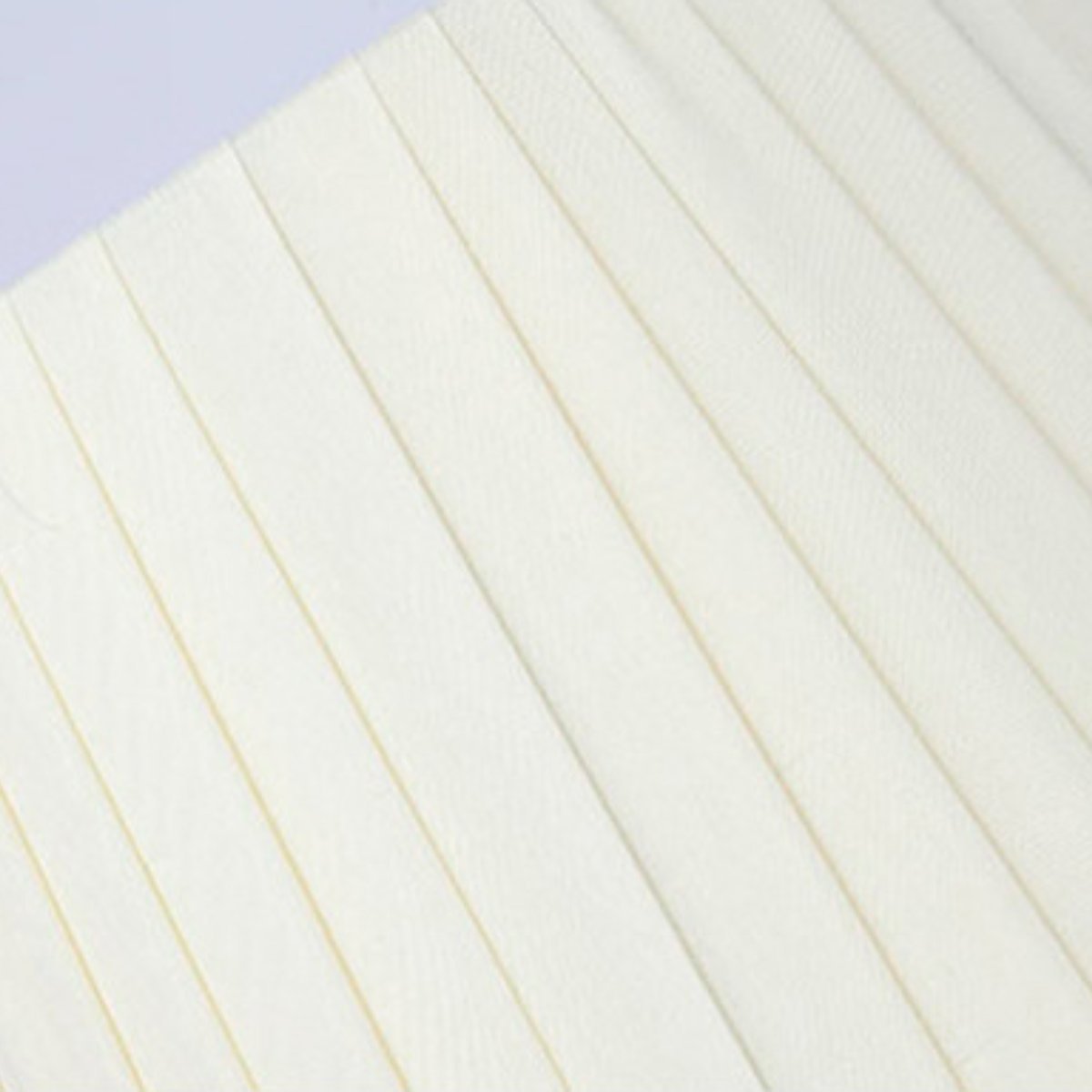 Close-up of Renée wall lamp fabric shade detail, white fabric with vertical lines