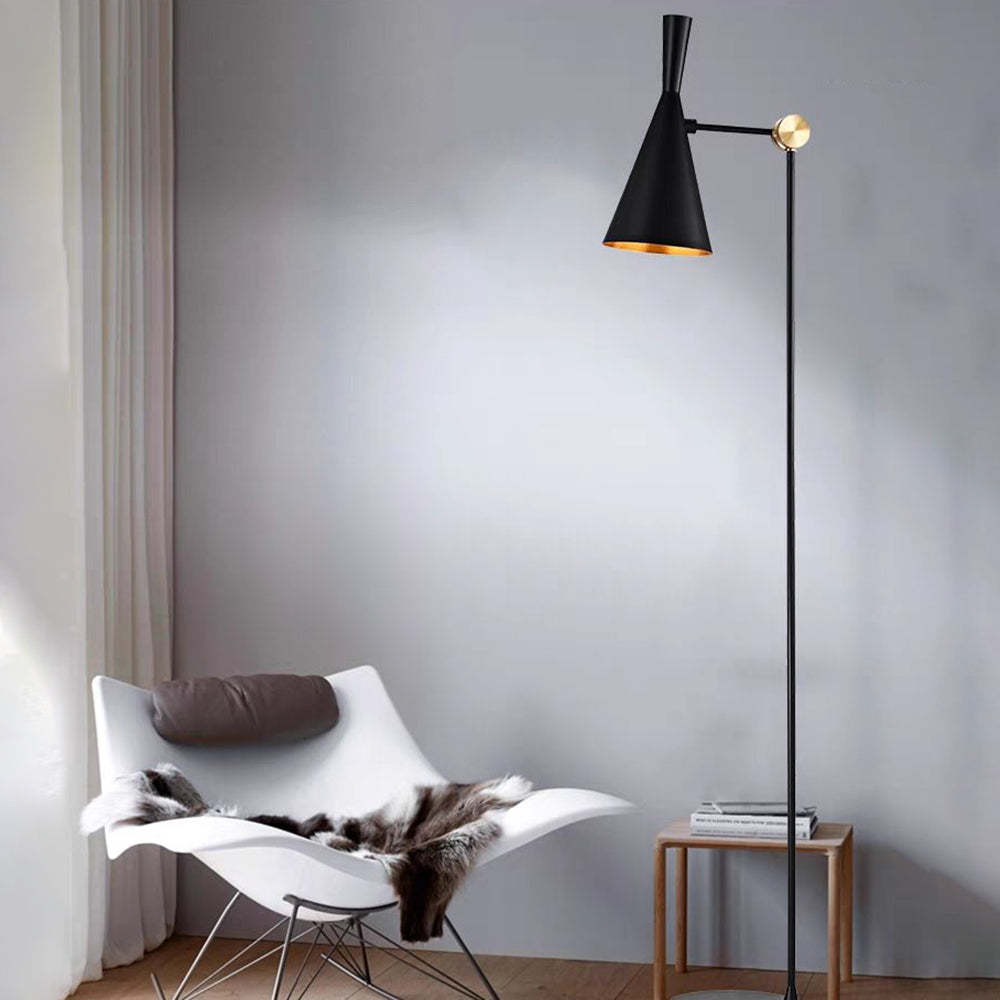 Modern floor lamp in minimalist living room with white chair.