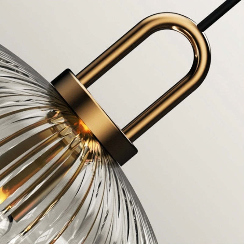 Sanna Pendant Light: Detail of ribbed glass shade and gold metal hardware.