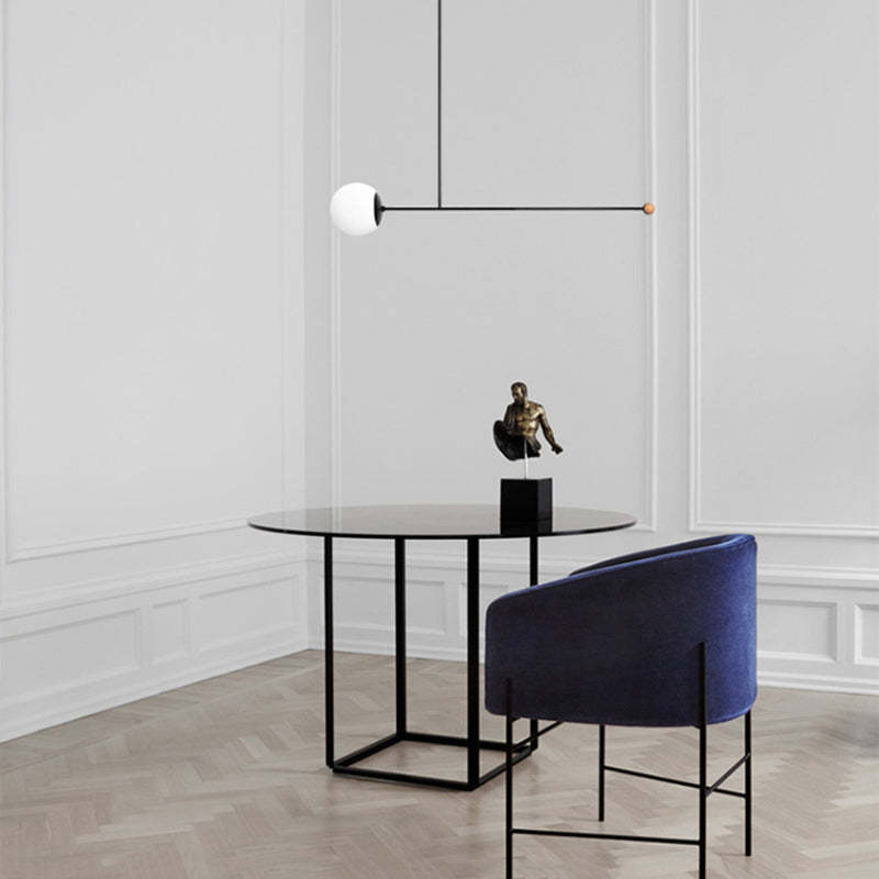 Avi LED Pendant Light over round table, modern living room.