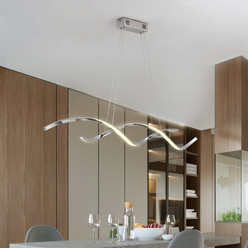Modern chrome wavy pendant light in a dining room