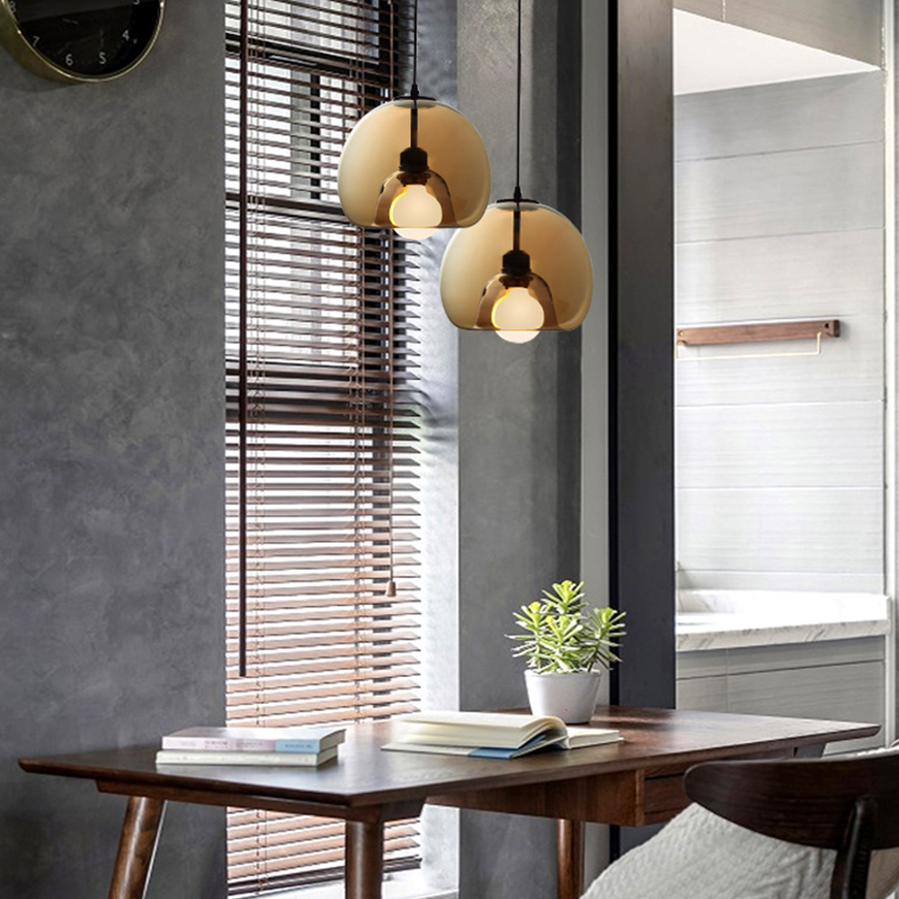 Amber globe pendant lights above dining table.